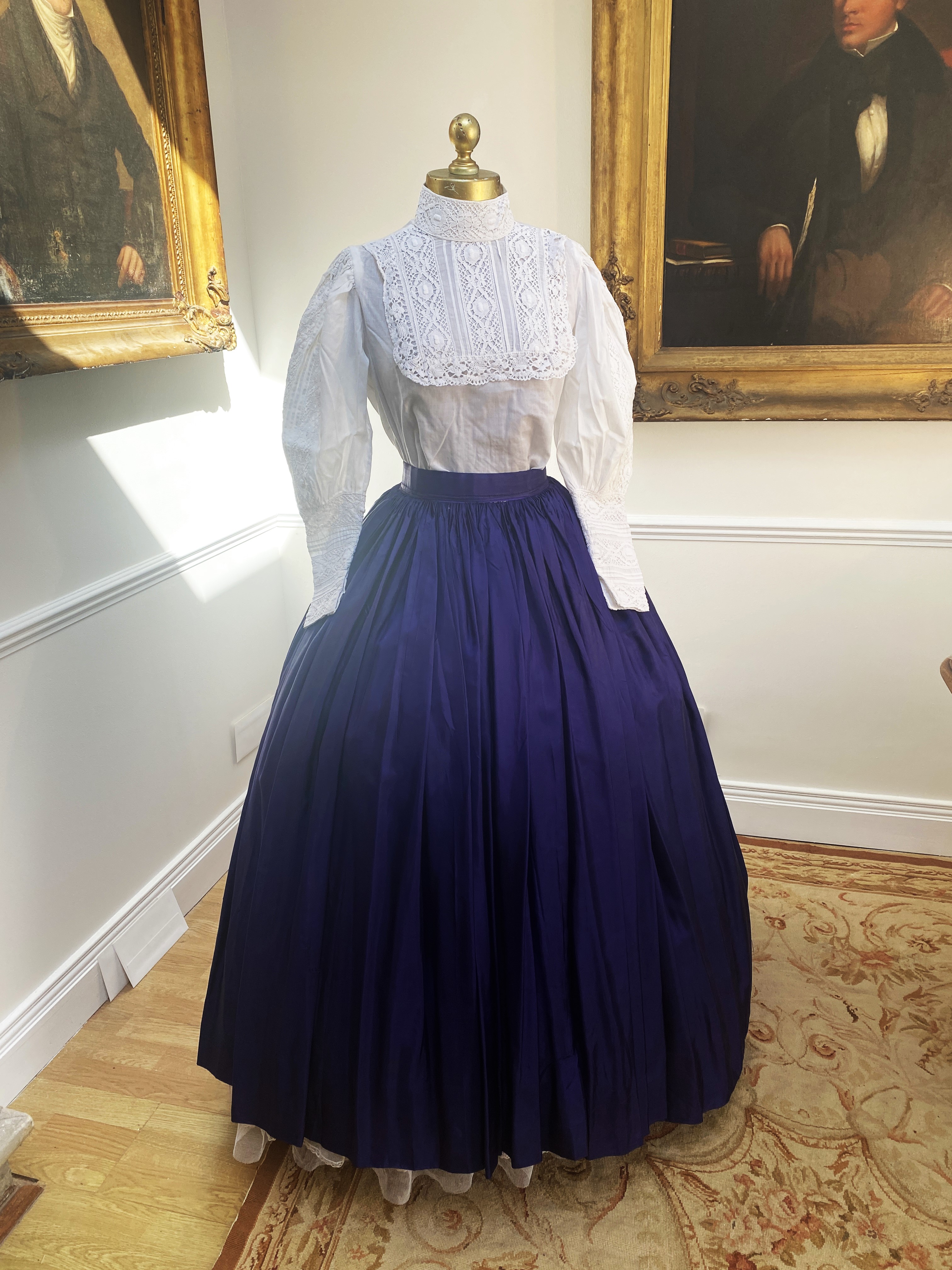 A Victorian style full skirt in peacock blue taffeta with white blouse and lace trim. Size Small/Medium.